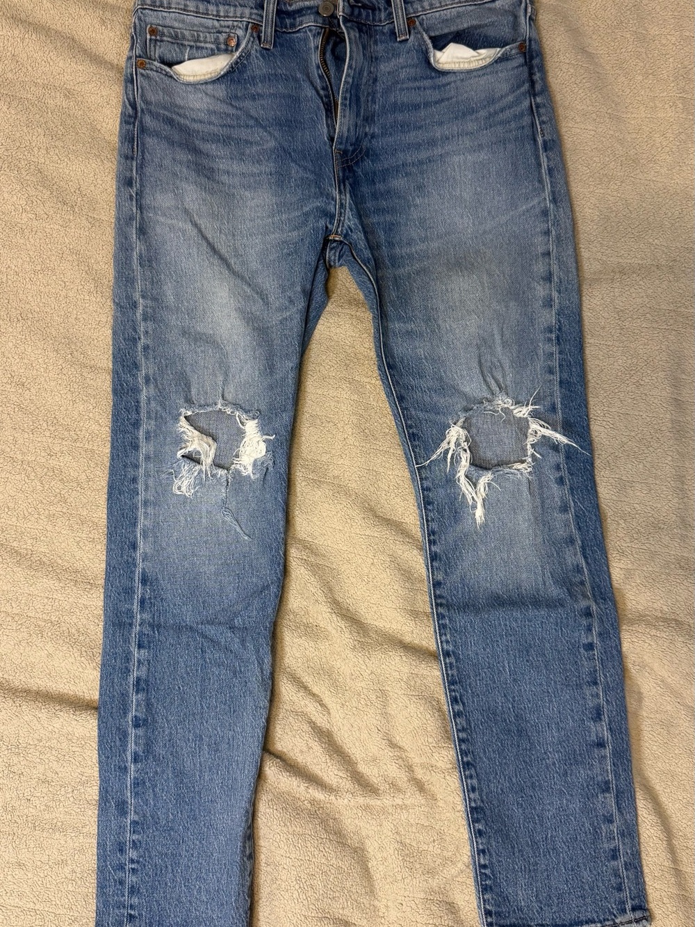 Levi's medium blue slim straight ripped knee jeans